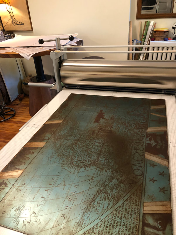 picture of inked etching plate on press bed