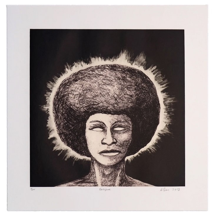 picture of woman with afro lit from behind

