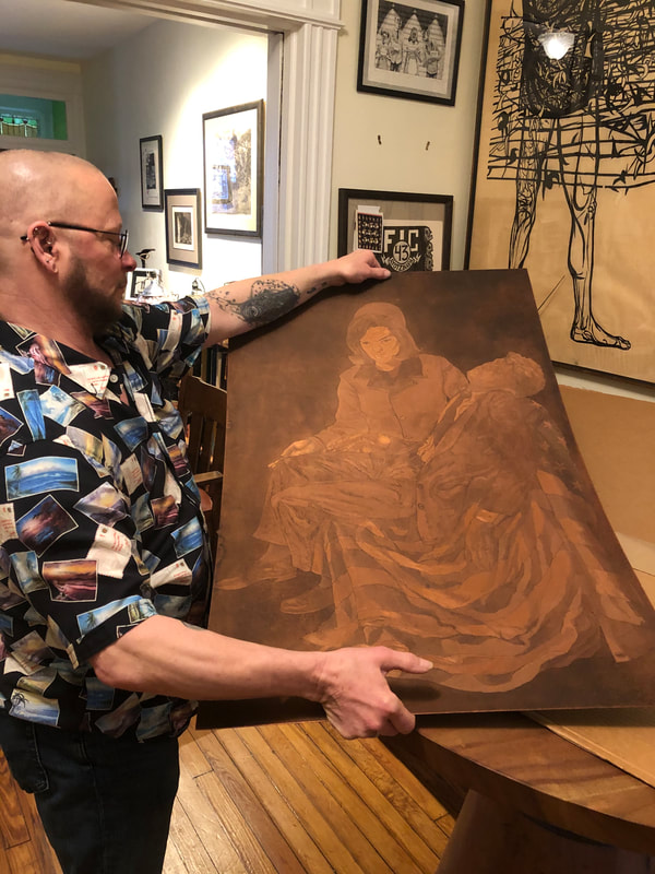 picture of man holding copper plate