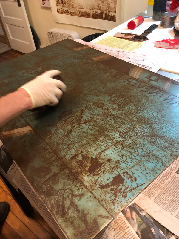 picture of a person wiping an etching plate